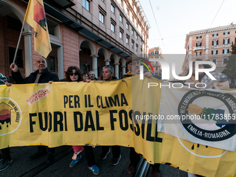 People wear animal masks and hold signs and banners as they participate in the street parade for the Climate Pride on November 16, 2024 in R...