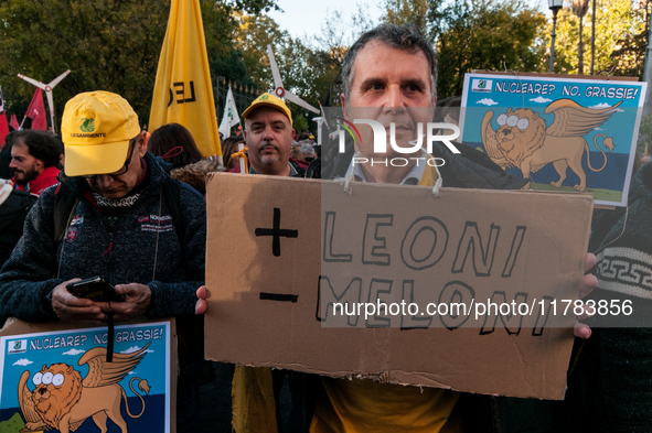 People wear animal masks and hold signs and banners as they participate in the street parade for the Climate Pride on November 16, 2024 in R...