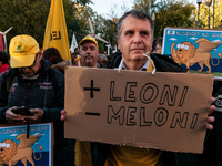 People wear animal masks and hold signs and banners as they participate in the street parade for the Climate Pride on November 16, 2024 in R...