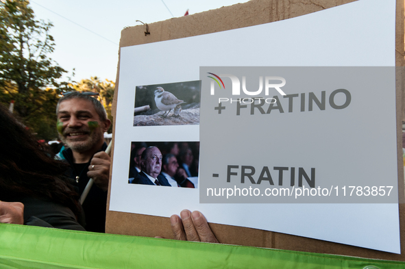 People wear animal masks and hold signs and banners as they participate in the street parade for the Climate Pride on November 16, 2024 in R...