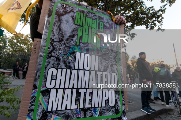 People wear animal masks and hold signs and banners as they participate in the street parade for the Climate Pride on November 16, 2024 in R...