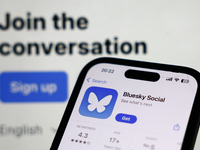 Bluesky Social website displayed on a laptop screen and Bluesky Social on App Store displayed on a phone screen are seen in this illustratio...