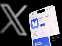 X logo displayed on a laptop screen and Bluesky Social on App Store displayed on a phone screen are seen in this illustration photo taken in...