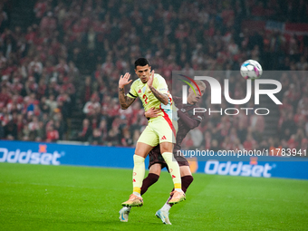 On November 15, 2024, in Copenhagen, Denmark, Pedro Porro of Spain fights for the ball with Albert Gronbeak of Denmark during the Nations Le...