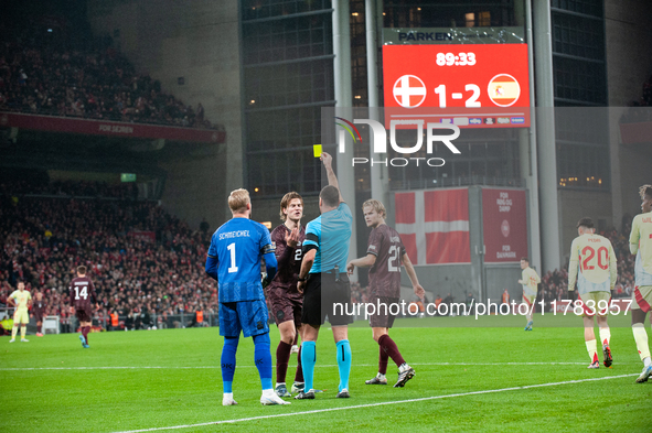 Joachim Andersen of Denmark receives a yellow card during the Nations League Round 5 match between Denmark and Spain at Parken Stadium in Co...