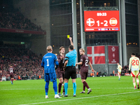 Joachim Andersen of Denmark receives a yellow card during the Nations League Round 5 match between Denmark and Spain at Parken Stadium in Co...