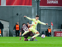 Martin Zubimendi of Spain fights for the ball with Christian Norgaard of Denmark during the Nations League Round 5 match between Denmark and...