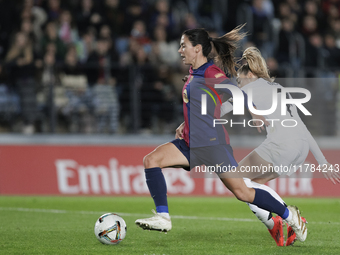 Aitana Bonmati of FC Barcelona and Olga Carmona of Real Madrid are in action during the LIGA F match between Real Madrid and FC Barcelona at...