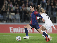 Aitana Bonmati of FC Barcelona and Olga Carmona of Real Madrid are in action during the LIGA F match between Real Madrid and FC Barcelona at...