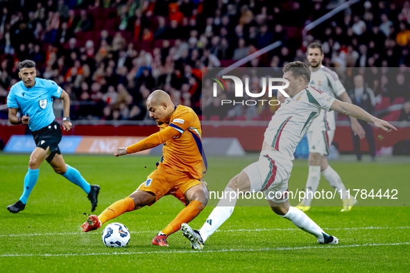 Netherlands forward Donyell Malen and Hungary defender Willi Orban play during the match between the Netherlands and Hungary at the Johan Cr...