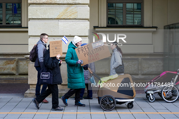 A demonstration in Munich, Germany, on November 16, 2024, includes pro-Palestinian demonstrators and pro-Israeli counter-demonstrators with...