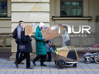 A demonstration in Munich, Germany, on November 16, 2024, includes pro-Palestinian demonstrators and pro-Israeli counter-demonstrators with...