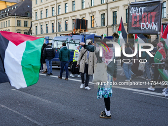 A demonstration in Munich, Germany, on November 16, 2024, includes pro-Palestinian demonstrators and pro-Israeli counter-demonstrators with...