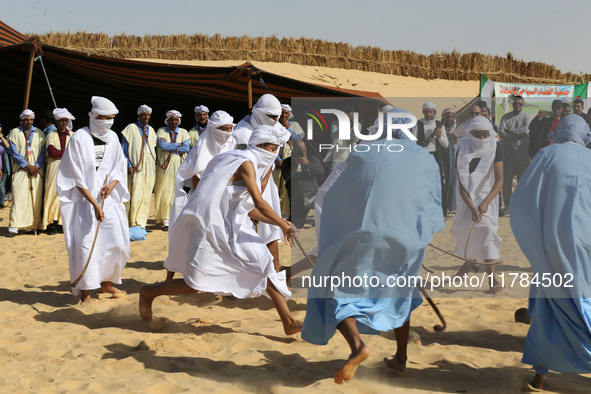 The photo, taken in Oued Souf, Algeria, on November 16, 2024, shows young Sahrawis playing a traditional game called taketchit during the In...