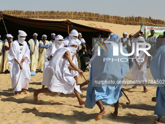 The photo, taken in Oued Souf, Algeria, on November 16, 2024, shows young Sahrawis playing a traditional game called taketchit during the In...