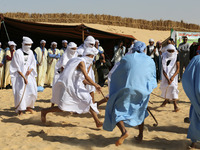 The photo, taken in Oued Souf, Algeria, on November 16, 2024, shows young Sahrawis playing a traditional game called taketchit during the In...