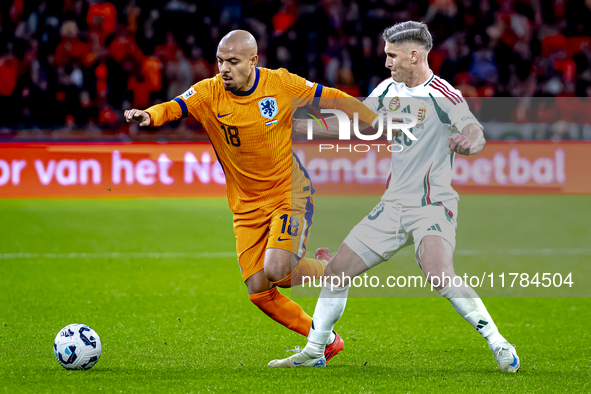 Netherlands forward Donyell Malen and Hungary forward Roland Sallai play during the match between the Netherlands and Hungary at the Johan C...