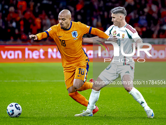 Netherlands forward Donyell Malen and Hungary forward Roland Sallai play during the match between the Netherlands and Hungary at the Johan C...