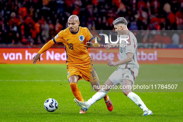 Netherlands forward Donyell Malen and Hungary forward Roland Sallai play during the match between the Netherlands and Hungary at the Johan C...