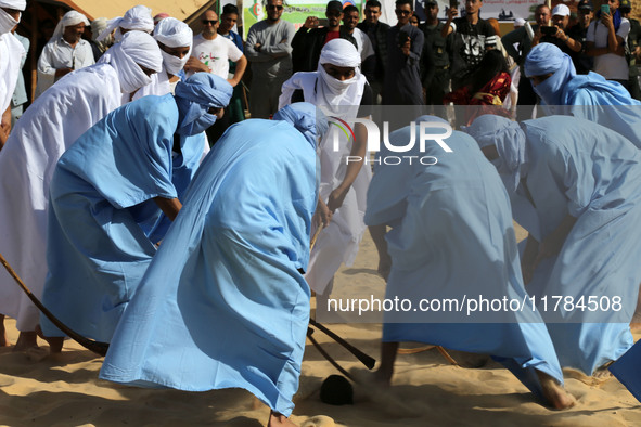 The photo, taken in Oued Souf, Algeria, on November 16, 2024, shows young Sahrawis playing a traditional game called taketchit during the In...