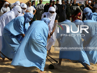 The photo, taken in Oued Souf, Algeria, on November 16, 2024, shows young Sahrawis playing a traditional game called taketchit during the In...