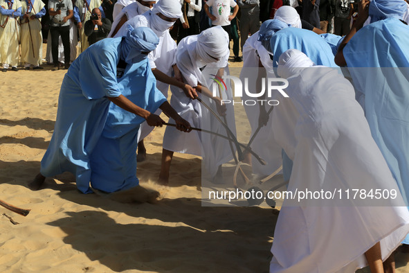 The photo, taken in Oued Souf, Algeria, on November 16, 2024, shows young Sahrawis playing a traditional game called taketchit during the In...