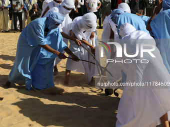 The photo, taken in Oued Souf, Algeria, on November 16, 2024, shows young Sahrawis playing a traditional game called taketchit during the In...