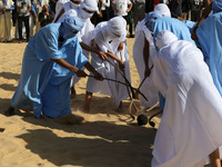 The photo, taken in Oued Souf, Algeria, on November 16, 2024, shows young Sahrawis playing a traditional game called taketchit during the In...