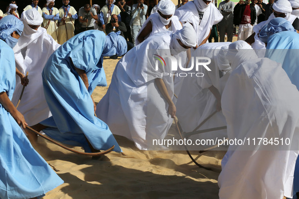 The photo, taken in Oued Souf, Algeria, on November 16, 2024, shows young Sahrawis playing a traditional game called taketchit during the In...