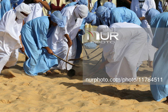 The photo, taken in Oued Souf, Algeria, on November 16, 2024, shows young Sahrawis playing a traditional game called taketchit during the In...