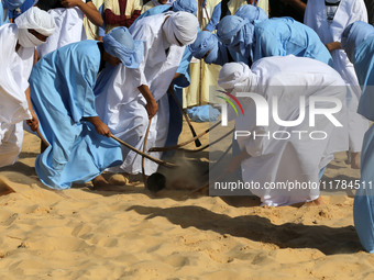 The photo, taken in Oued Souf, Algeria, on November 16, 2024, shows young Sahrawis playing a traditional game called taketchit during the In...