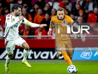 Hungary midfielder Dominik Szoboszlai and Netherlands forward Noa Lang participate in the match between the Netherlands and Hungary at the J...