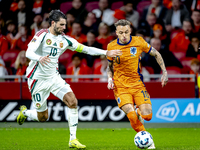 Hungary midfielder Dominik Szoboszlai and Netherlands forward Noa Lang participate in the match between the Netherlands and Hungary at the J...