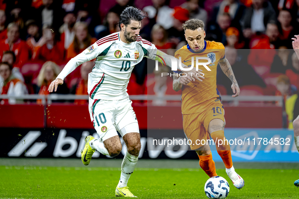 Hungary midfielder Dominik Szoboszlai and Netherlands forward Noa Lang participate in the match between the Netherlands and Hungary at the J...