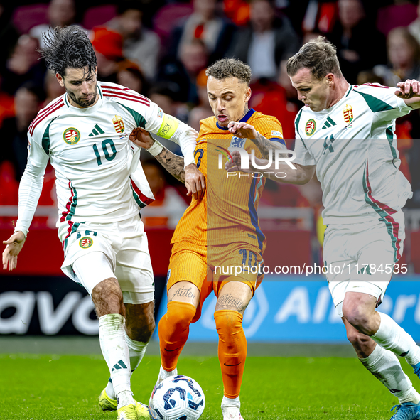 Hungary midfielder Dominik Szoboszlai and Netherlands forward Noa Lang participate in the match between the Netherlands and Hungary at the J...