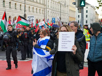 A demonstration in Munich, Germany, on November 16, 2024, includes pro-Palestinian demonstrators and pro-Israeli counter-demonstrators with...