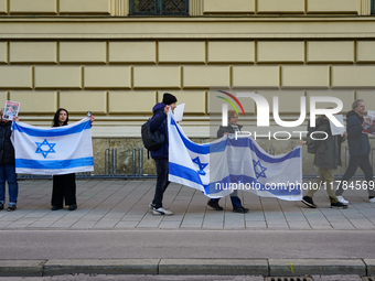 A demonstration in Munich, Germany, on November 16, 2024, includes pro-Palestinian demonstrators and pro-Israeli counter-demonstrators with...