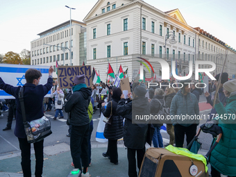 A demonstration in Munich, Germany, on November 16, 2024, includes pro-Palestinian demonstrators and pro-Israeli counter-demonstrators with...