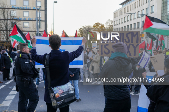 A demonstration in Munich, Germany, on November 16, 2024, includes pro-Palestinian demonstrators and pro-Israeli counter-demonstrators with...