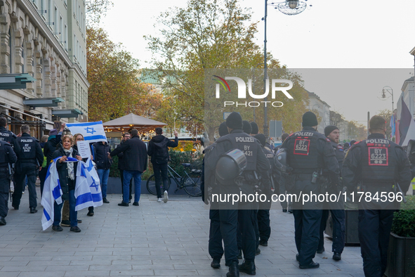 A demonstration in Munich, Germany, on November 16, 2024, includes pro-Palestinian demonstrators and pro-Israeli counter-demonstrators with...