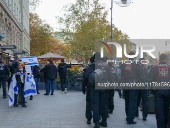 A demonstration in Munich, Germany, on November 16, 2024, includes pro-Palestinian demonstrators and pro-Israeli counter-demonstrators with...