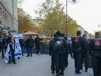 A demonstration in Munich, Germany, on November 16, 2024, includes pro-Palestinian demonstrators and pro-Israeli counter-demonstrators with...