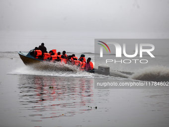 Officials of INEC in a boat in Ugbonla, Ilaje, Local Government Area, Ondo State, Nigeria, on November 16, 2024, take election materials to...