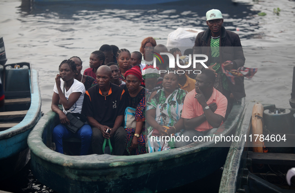 Residents in a boat in Ugbonla, Ilaje, Local Government Area, Ondo State, Nigeria, head to their polling unit during the 2024 Governorship e...