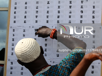 A traditional chief checks his name on voters' lists during the 2024 Governorship election for Ondo State in Obenla, Ilaje, Local Government...