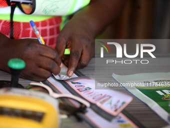 An INEC official signs a ballot paper during the 2024 Governorship election for Ondo State in Obenla, Ilaje, Local Government Area, Ondo Sta...