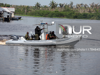 Military personnel patrol on the water during the 2024 Governorship election for Ondo State in Obenla, Ilaje, Local Government Area, Ondo St...