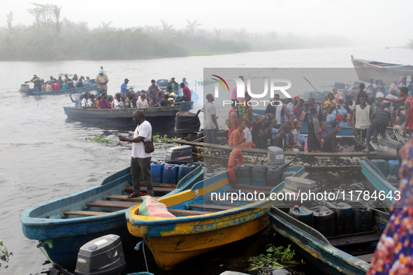 Residents in a boat in Ugbonla, Ilaje, Local Government Area, Ondo State, Nigeria, head to their polling unit during the 2024 Governorship e...