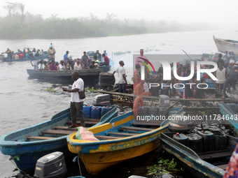 Residents in a boat in Ugbonla, Ilaje, Local Government Area, Ondo State, Nigeria, head to their polling unit during the 2024 Governorship e...