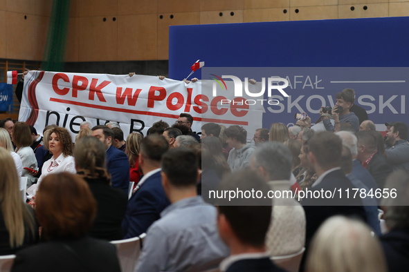 In Krakow, Poland, on November 16, 2024, people with a banner and hats with the inscription 'Mentzen 2025' disrupt the event during a meetin...